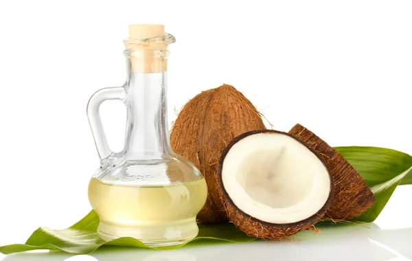 Decanter with coconut oil and coconuts isolated on white — Stock Photo, Image