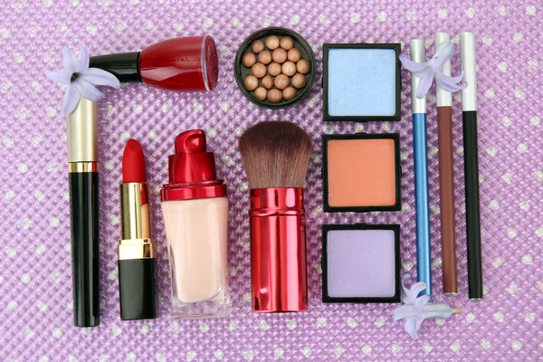 Decorative cosmetics on purple background — Stock Photo, Image