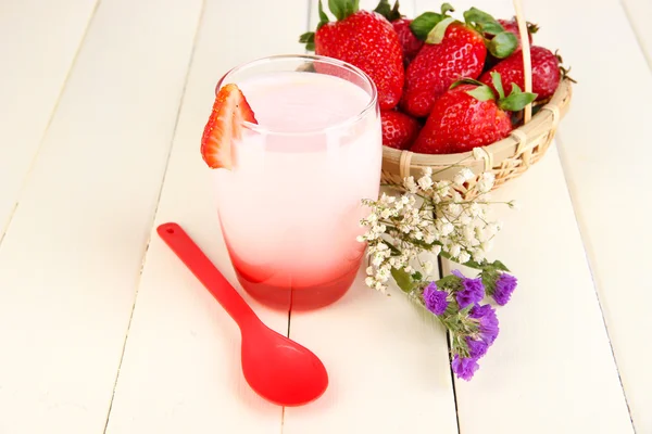 Delicious strawberry yogurt in glass on wooden table close-up — Stock Photo, Image