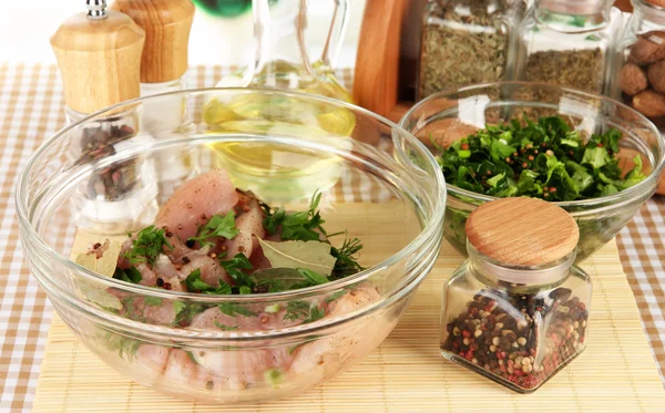 Hühnerfleisch in Glasschüssel, Kräuter und Gewürze auf karierter Serviette in Großaufnahme — Stockfoto