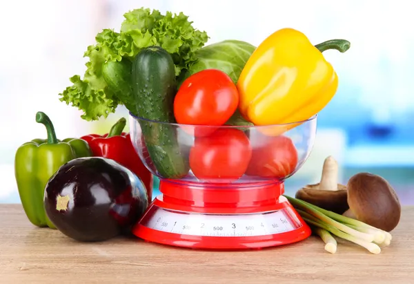 Fresh vegetables in scales on table in kitchen — Stock Photo, Image