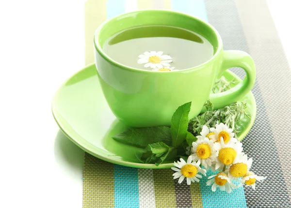 Cup of herbal tea with wild camomiles and mint, isolated on white — Stock Photo, Image