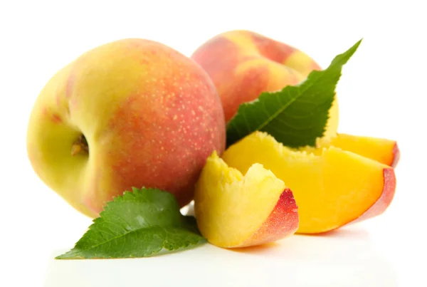 Ripe sweet peaches with leaves, isolated on white — Stock Photo, Image