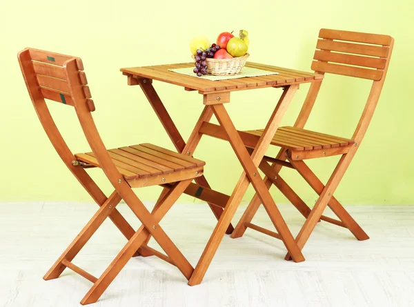 Wooden table with fruit in room — Stock Photo, Image