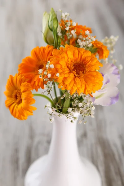 Calendula flowers in vase on wooden background — Stock Photo, Image