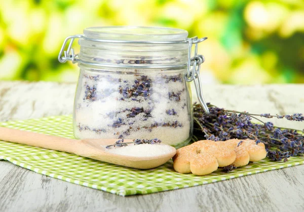 Jar of lavender sugar and fresh lavender flowers on bright background — Stock Photo, Image