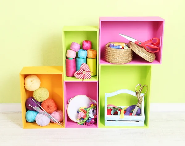 Colorful shelves of different colors with utensils on wall background — Stock Photo, Image