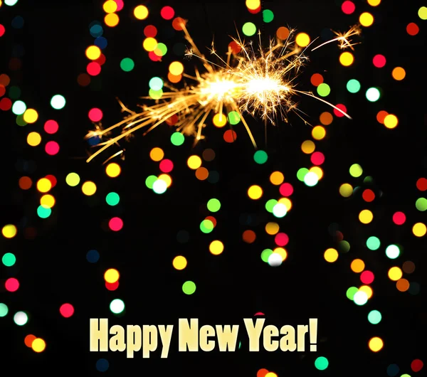 Beautiful sparklers on garland background — Stock Photo, Image