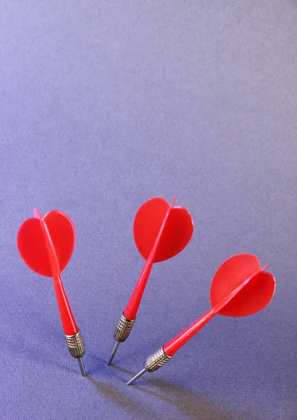 Darts on purple background — Stock Photo, Image