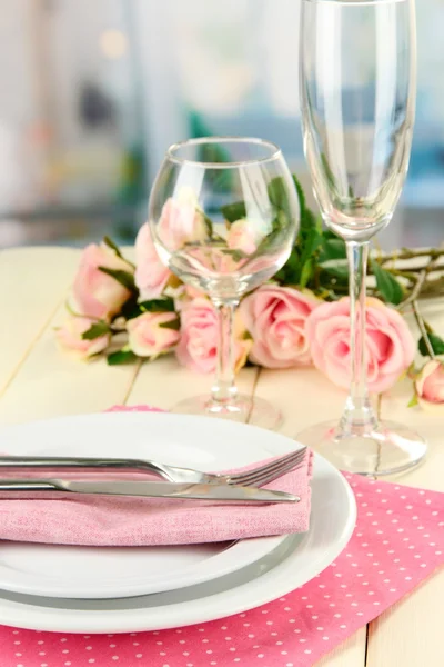 Table serving on a wooden background on the background of the room — Stock Photo, Image