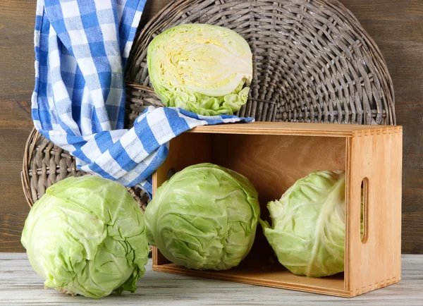 Cabbage on table on wooden background — Stock Photo, Image