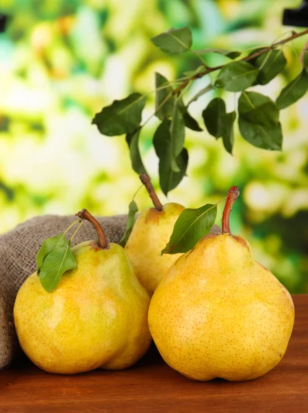 Juicy pears on table on bright background — Stock Photo, Image