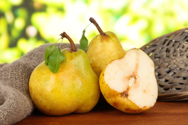 Juicy pears on table on bright background — Stock Photo, Image