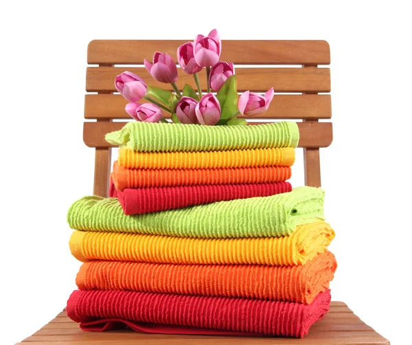 Towels and flowers on wooden chair isolated on white — Stock Photo, Image