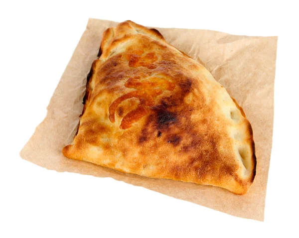 Pizza calzone on tracing paper isolated on white — Stock Photo, Image