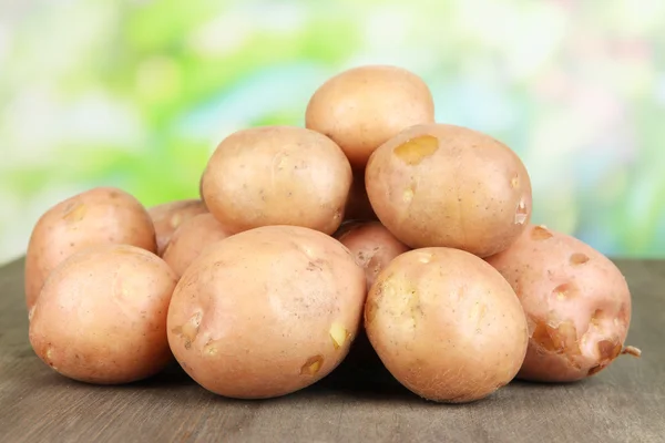 Potato on wooden table — Stock Photo, Image