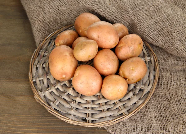 Potato on wooden table — Stock Photo, Image