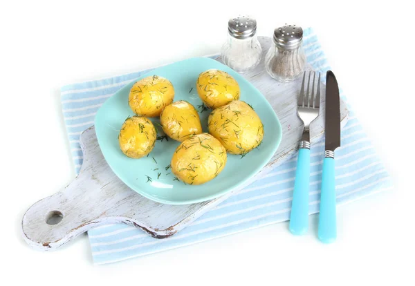 Boiled potatoes on platen on wooden board on napkin isolated on white — Stock Photo, Image