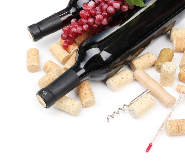 Bottles of wine, grapes and corks, isolated on white — Stock Photo, Image