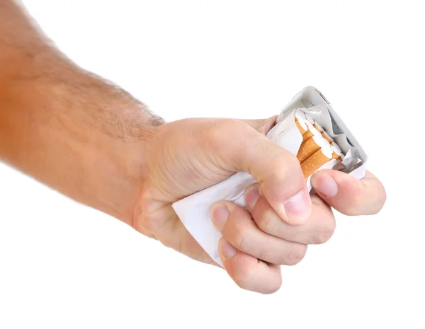 Fist with crushed pack of cigarettes, isolated on white — Stock Photo, Image