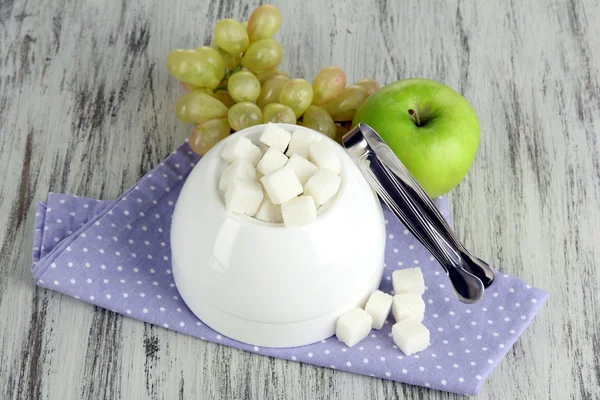 Refined sugar in white sugar bowl on wooden background — Stock Photo, Image