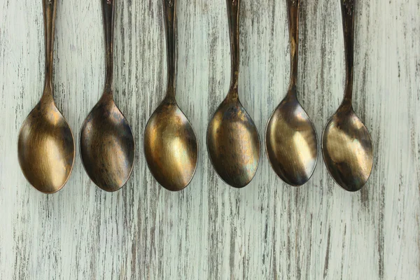 Vintage metal spoons on wooden table close-up — Stock Photo, Image