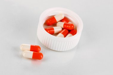 Dağıtıcı üzerinde beyaz izole haplarla tabletler için