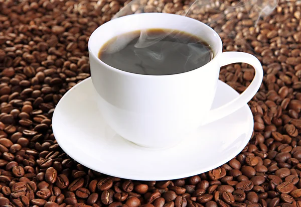 Taza de café sobre fondo de granos de café — Foto de Stock
