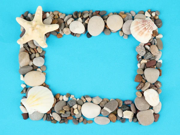 Frame of sea stones on color background — Stock Photo, Image