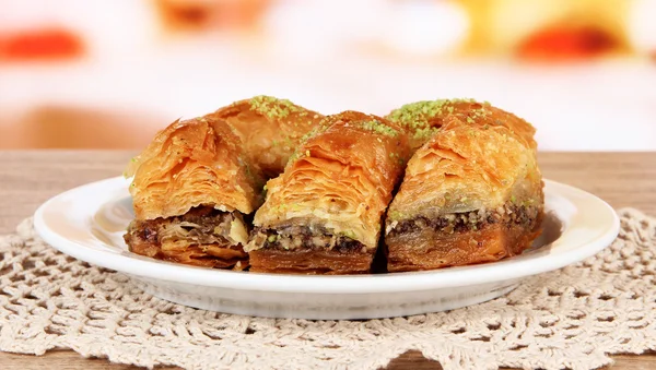 Sweet baklava on plate on table in room — Stock Photo, Image