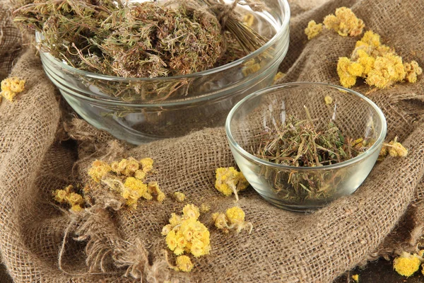 Medicinal Herbs in glass bowls on bagging close-up — Stock Photo, Image