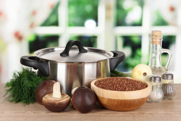 Ingredients for cooking buckwheat on table in kitchen — Stock Photo, Image