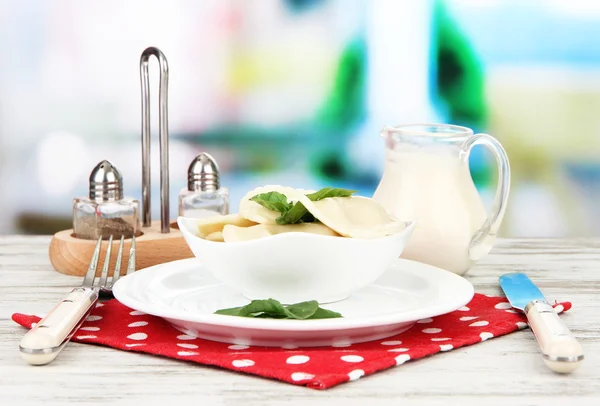 Tasty dumplings on white plate, on bright background — Stock Photo, Image