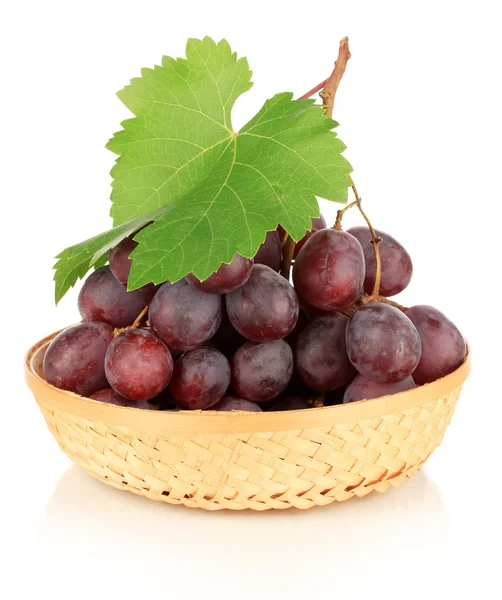 Ripe delicious grapes in wicker basket isolated on white — Stock Photo, Image