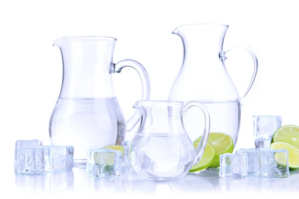 Glass pitchers of water with ice and lime isolated on white — Stock Photo, Image