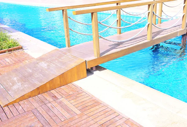 Bridge across hotel swimming pool — Stock Photo, Image