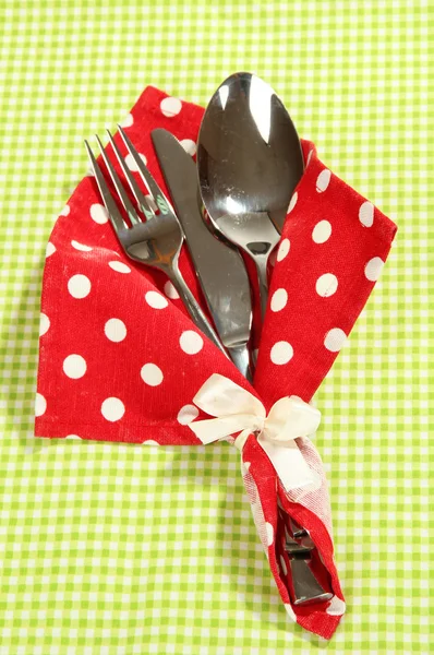 Fork,spoon,knife in napkin on bright background — Stock Photo, Image