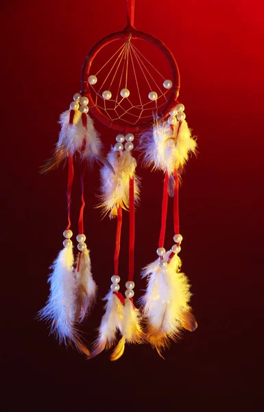 Beautiful dream catcher on dark red background — Stock Photo, Image