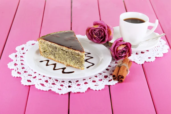 Delicious poppy seed cake with cup of coffee on table close-up — Stock Photo, Image