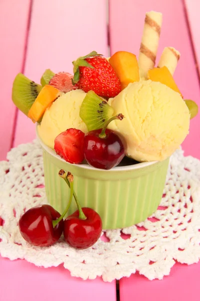 Delicious ice cream with fruits and berries in bowl on wooden table — Stock Photo, Image