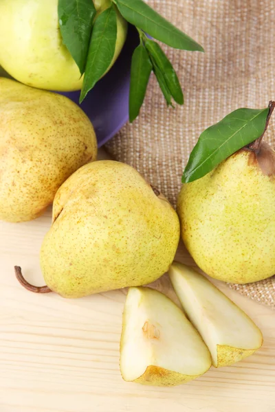 Pears in bucket on burlap on wooden table — Stock Photo, Image