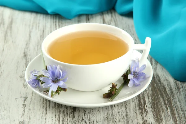 Cup of tea with chicory, on wooden background — Stock Photo, Image