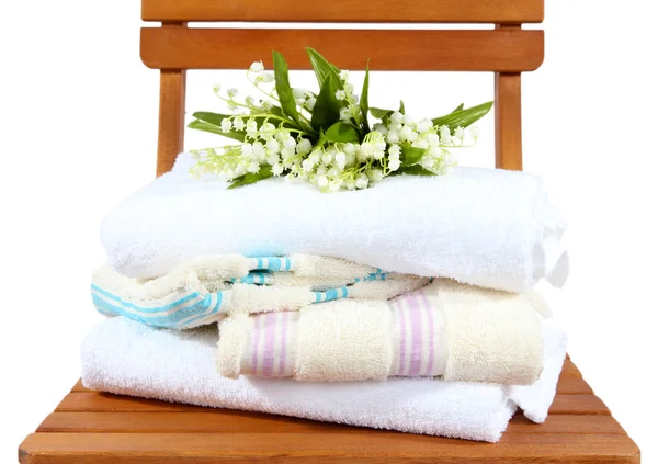 Towels and flowers on wooden chair isolated on white — Stock Photo, Image