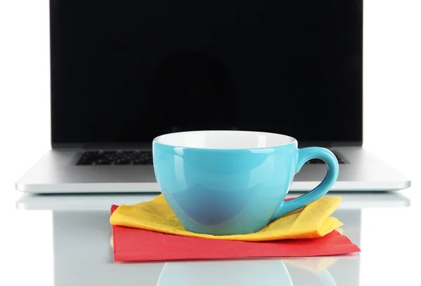 Blue cup on napkin on laptop background isolated on white — Stock Photo, Image