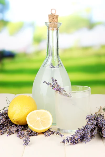 Lavender lemonade in bottle, on bright background — Stock Photo, Image