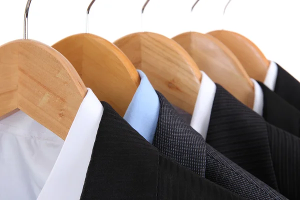 Suits with shirts on hangers on white background — Stock Photo, Image
