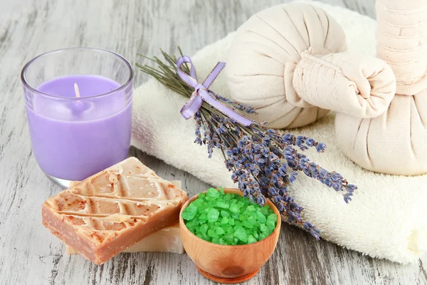 Still life with lavender candle, soap, massage balls, soap and fresh lavender, on wooden background — Stock Photo, Image