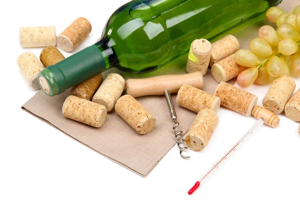 Bottle of wine, grapes and corks, isolated on white — Stock Photo, Image