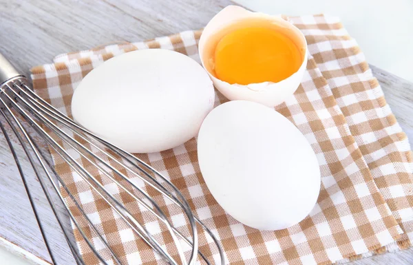 Corolla and eggs on wooden board isolated on white — Stock Photo, Image