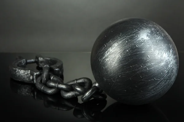 Ball and chain on grey background